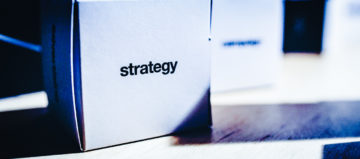 image of a box, with the word strategy written on it, placed on a desk